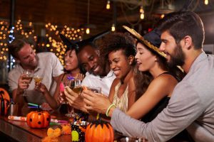 Individuals at a bar on Halloween