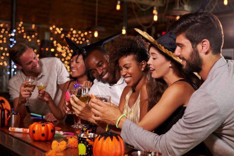 Individuals at a bar on Halloween