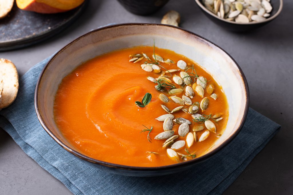 Close-up of vegetarian pumpkin cream soup, vegetable puree for Thanksgiving