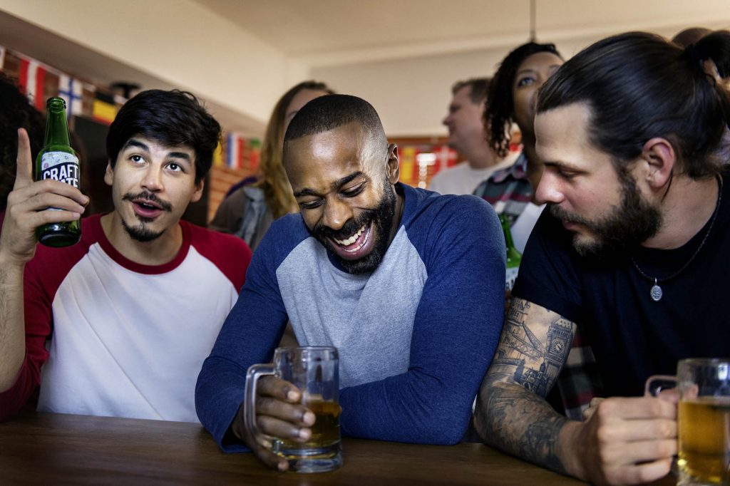 Friends cheering at a bar together