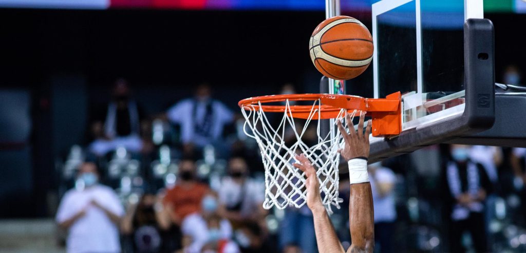 basketball going through the hoop at a sports arena