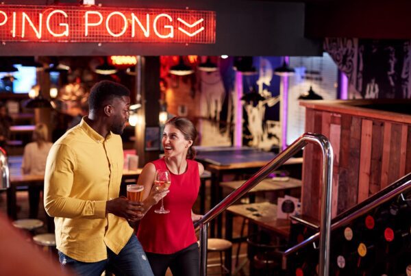 Climbing Stairs with Drinks In Bar