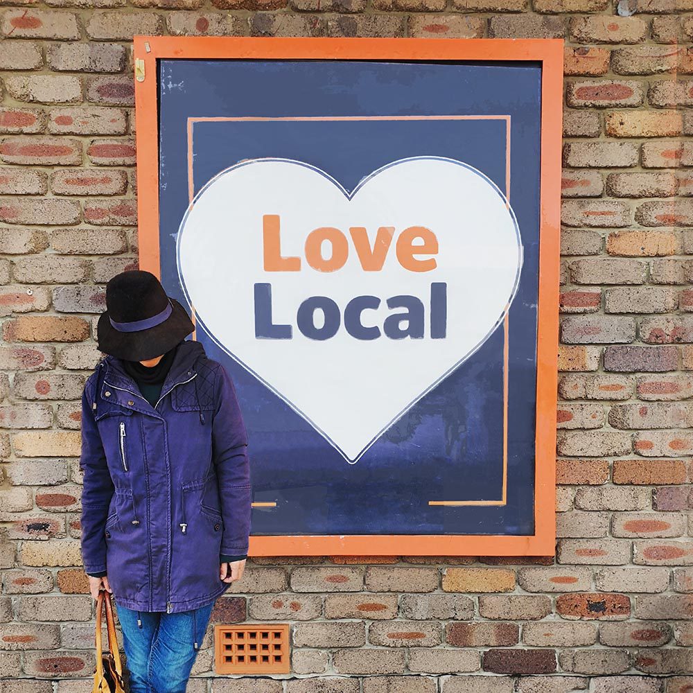 Woman standing with a local love sign