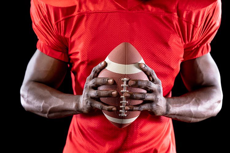 Football player holding the ball