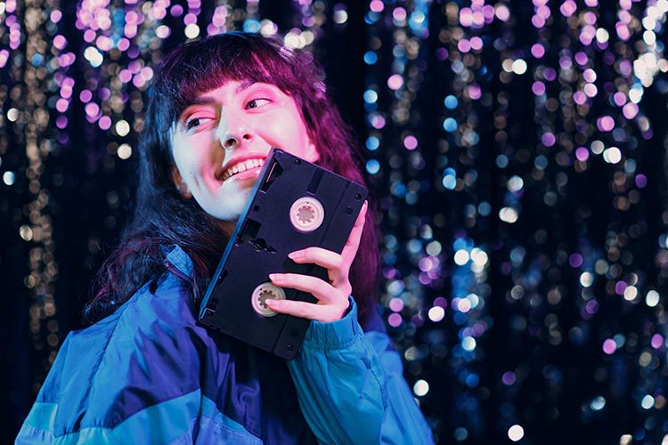 Woman holding a VHS Tape