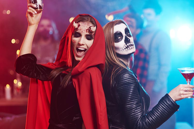 Women in costumes dancing at Halloween event