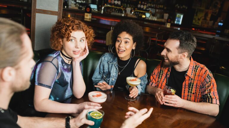 People sitting around a table with drinks in their hands