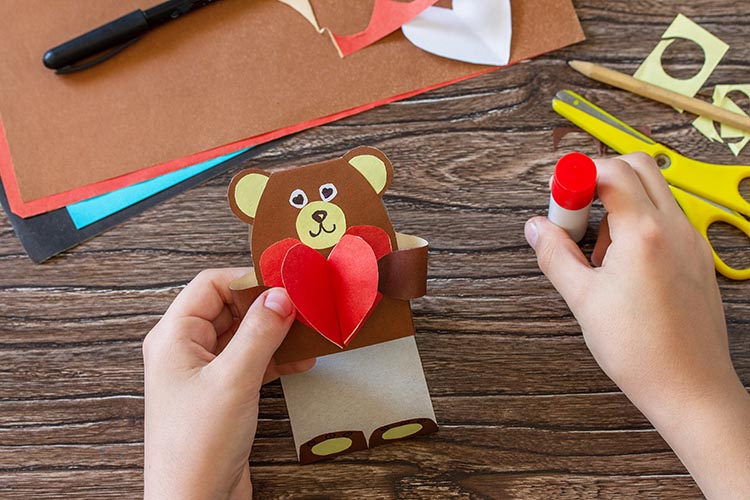 kid crafting a teddy bear valentine