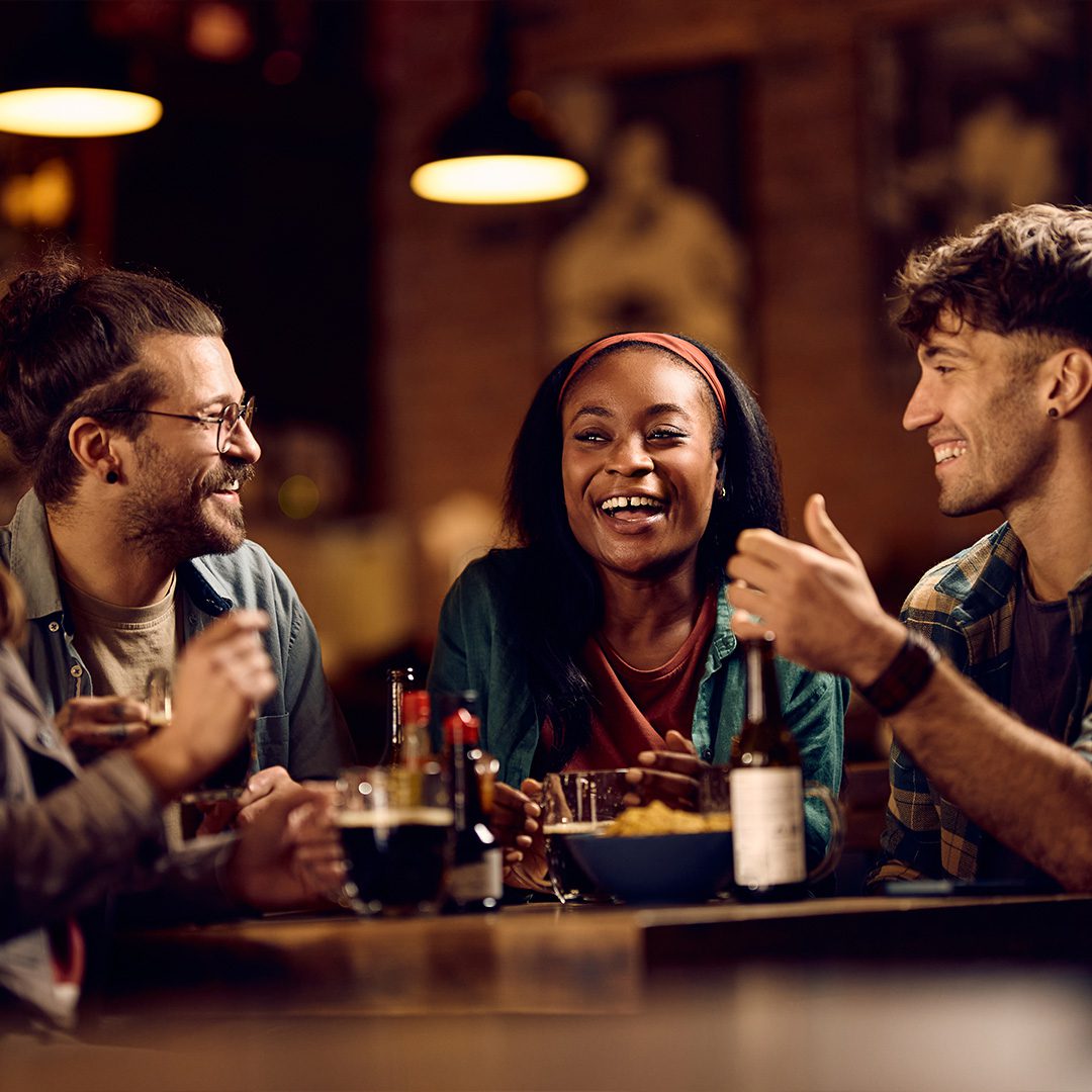 people at the pub laughing at table