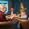 Grandma, mom, and child holding hands at a restaurant while sitting in chairs