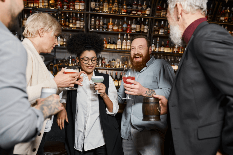 People at the bar sharing cocktails