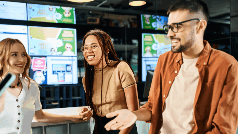 People standing around a bar with digital signage in the background