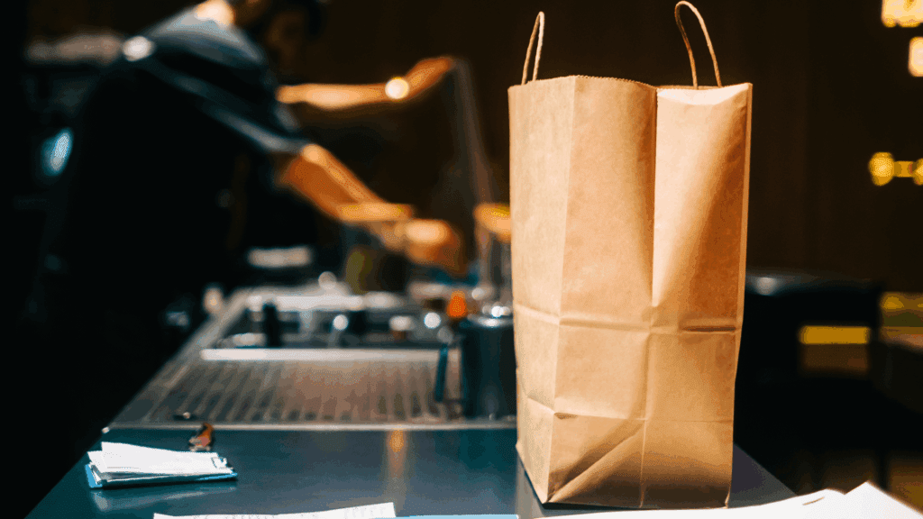 Paper bag on a commercial counter waiting for pickup