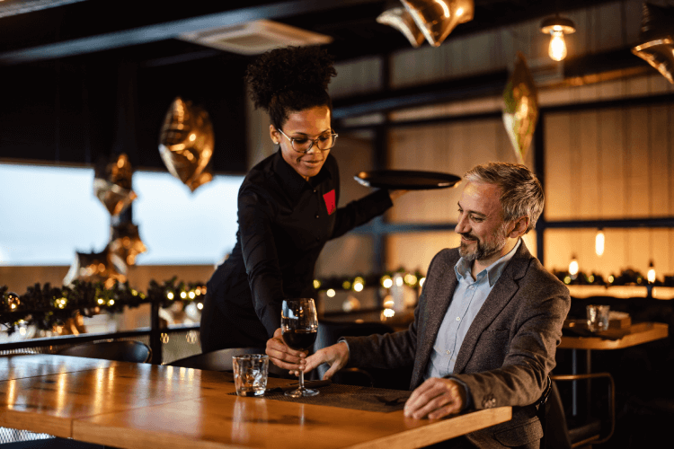 Woman server delivering some wine