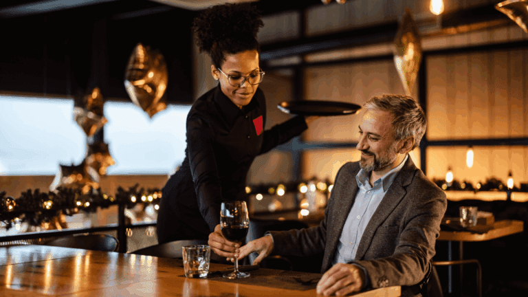 Woman serving man some wine