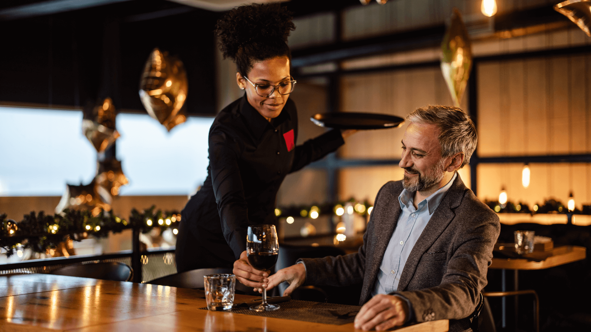 Woman serving man some wine