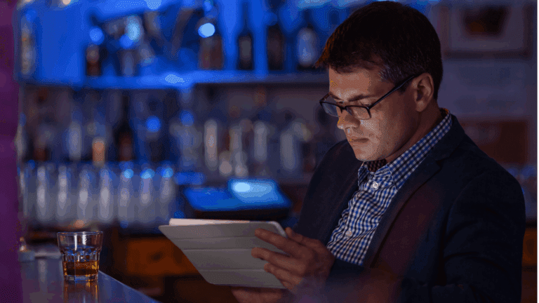 Person reading at the bar