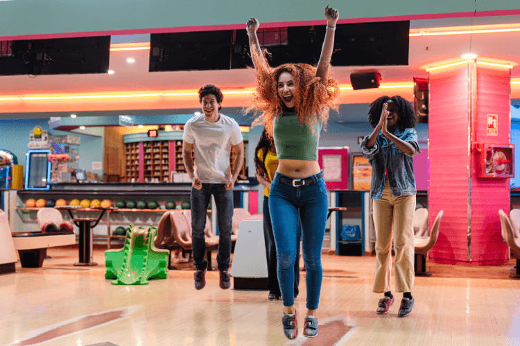 Friends bowling in the lane
